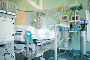 Patient connected to the life-supporting equipment in the ICU, unfocused backgound photo