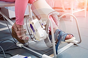 Patient on CPM machines, continuous passive range of motion.