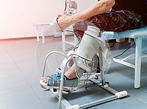 Patient on CPM machines, continuous passive range of motion.