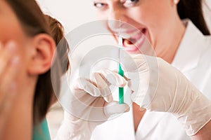 Patient at dentist receiving anesthetization