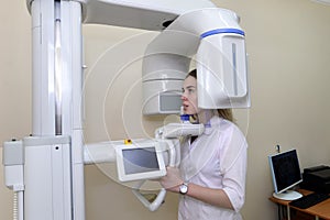 Patient in a dentist`s panoramic and cephalometric x-ray system photo