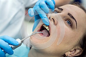 Patient in dentistry with stomatological tools, closeup