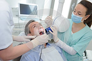 Patient in dentists panoramic and cephalometric x-ray system photo
