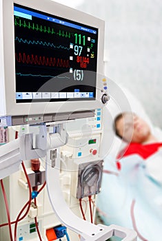 Patient at dialysis procedure with ECG monitor