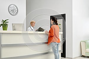 Patient and doctor with folder on reception.