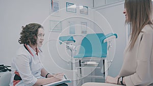 Patient and doctor in the gynecologist`s office: a gynecological chair