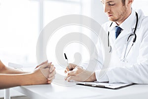 Patient and doctor taking notes photo