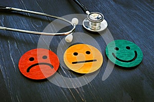 Patient experience concept. Stethoscope and smiled faces for hospital consumer assessment. photo