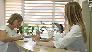 The patient fill form at reception of clinic