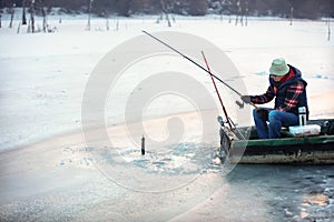 Patient fisherman pulls hooked fish from water