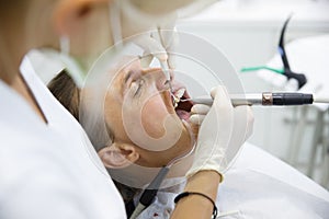 Patient getting her gum pocket depth measured