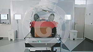 Patient getting radiation therapy treatment inside a modern radiotherapy room