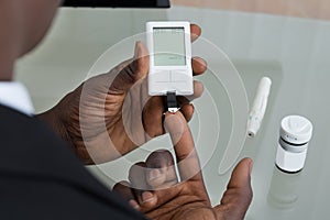 Patient Hands With Glucometer