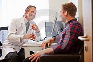 Patient Having Consultation With Male Doctor In Office