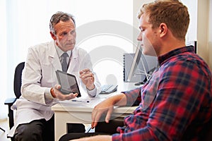 Patient Having Consultation With Male Doctor In Office photo