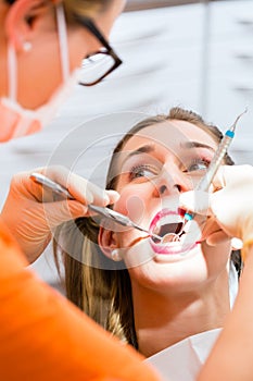 Patient having deep dental tooth cleaning