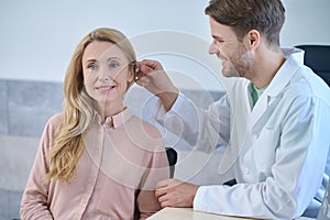 Patient having her hearing device fixed by a qualified doctor