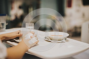 Patient having a light meal in her hospital bed