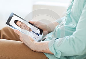 Patient having video chat with doctor on tablet pc