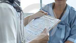 Patient health insurance claim form in doctor or nurse hands for medicare coverage and medical treatment from illness photo