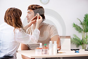 The patient with hearing problem visiting doctor otorhinolaryngologist photo