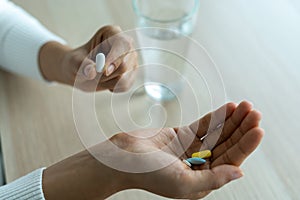 The patient holds the medicine in hand. Medicines to treat diseases or take vitamin supplements for people are malnourished