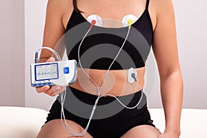 Patient With Holter Monitor Device On Her Body In Clinic