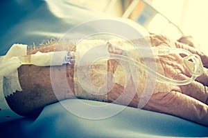 Patient In Hospital Bed And Having Iv Solution Drop