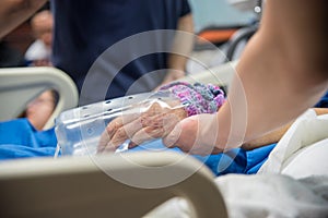 Patient in the hospital and holding a hand