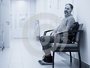 Patient in hospital waiting room. Filtered monochrome image