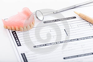 Patient information form and dentures with dental glass with pen