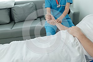 Patient on an inpatient hospital bed with a doctor examining and asking for information about the symptoms in order to diagnose