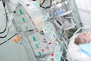 Patient on intensive care connected to devices for perfusion of photo