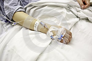 Patient With IV Lines in Hospital Bed