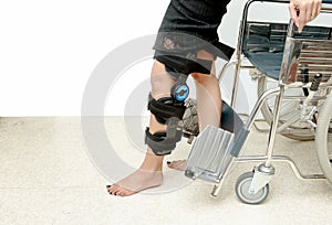 Patient on knee brace support try to walk training,Rehabilitation treatment photo