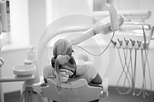 The patient lies in a chair in the dental clinic