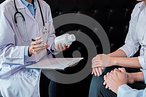 Patient listening intently to a male doctor explaining patient s