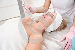 Patient is located on cosmetology couch for laser skin resurfacing procedure