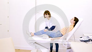 Patient lying on a stretcher attended by a friendly nurse photo