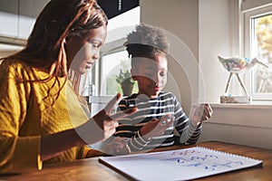 Patient mom teaching daughter schoolwork