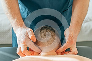 Patient with neck pain getting acupressure massage from doctor therapist masseur, close up. Chinese medicine treatment