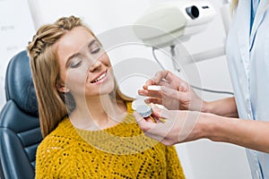 patient and optician with contact lens