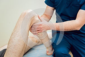 Patient with orthopedist doctor in his office.