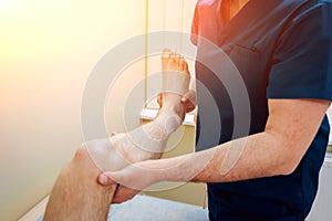 Patient with orthopedist doctor in his office.