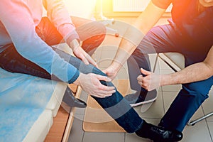 Patient with orthopedist doctor in his office.