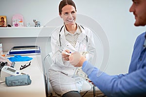 Patient paying to doctor for examine