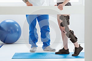 Patient and physiotherapist at the appointment in orthopedic clinics photo