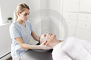 Patient at the physiotherapy doing physical exercises with his therapist