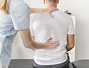 Patient at the physiotherapy doing physical exercises with his therapist