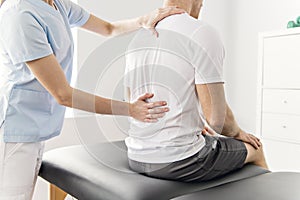 Patient at the physiotherapy doing physical exercises with his therapist